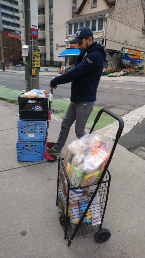 picture of a volunteer delivering donated groceries