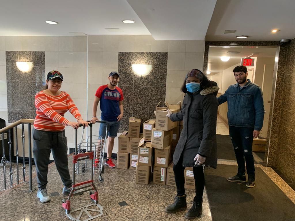 Picture of 4 volunteers delivering groceries